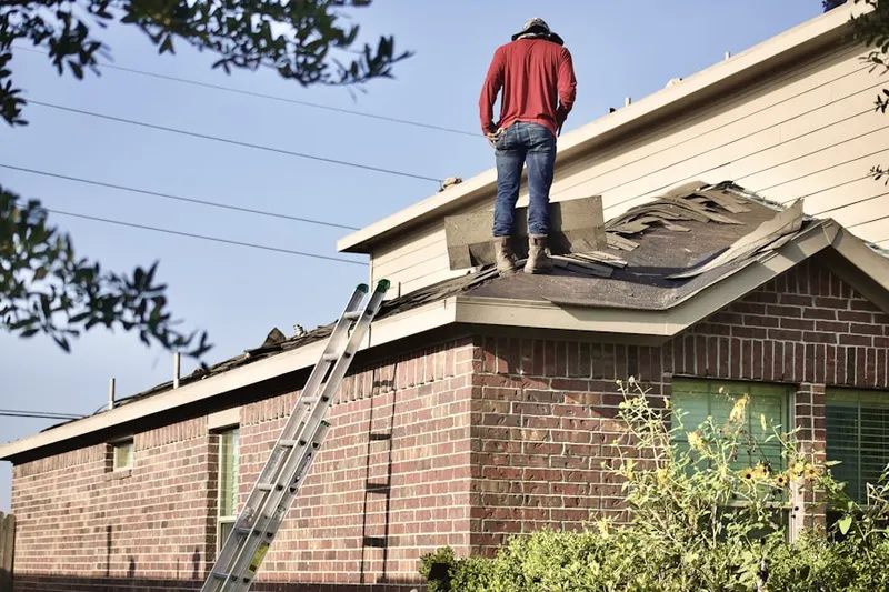 Professional roofer working on a residential roof in Topanga Park